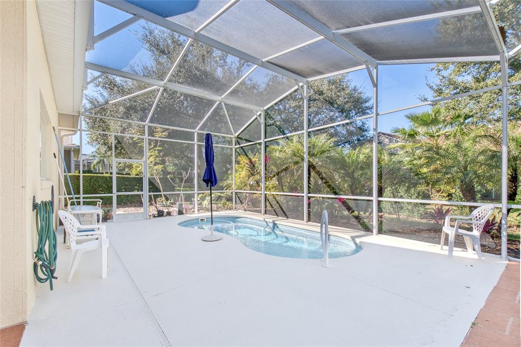 2808 Falcon Ridge Clermont, FL 34711 - Photo 35 of 65 a view of a swimming pool with outdoor seating