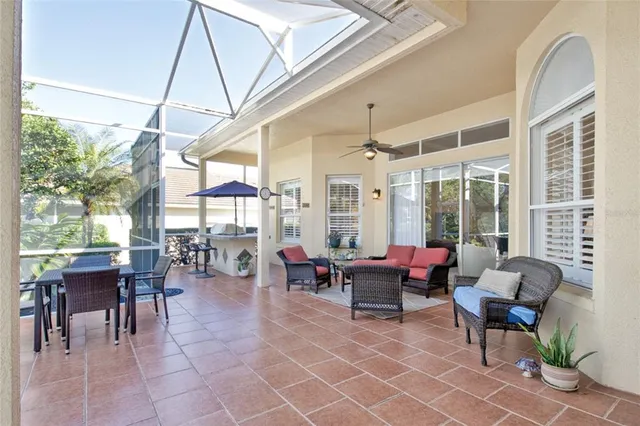 a view of a house with backyard swimming pool and sitting area