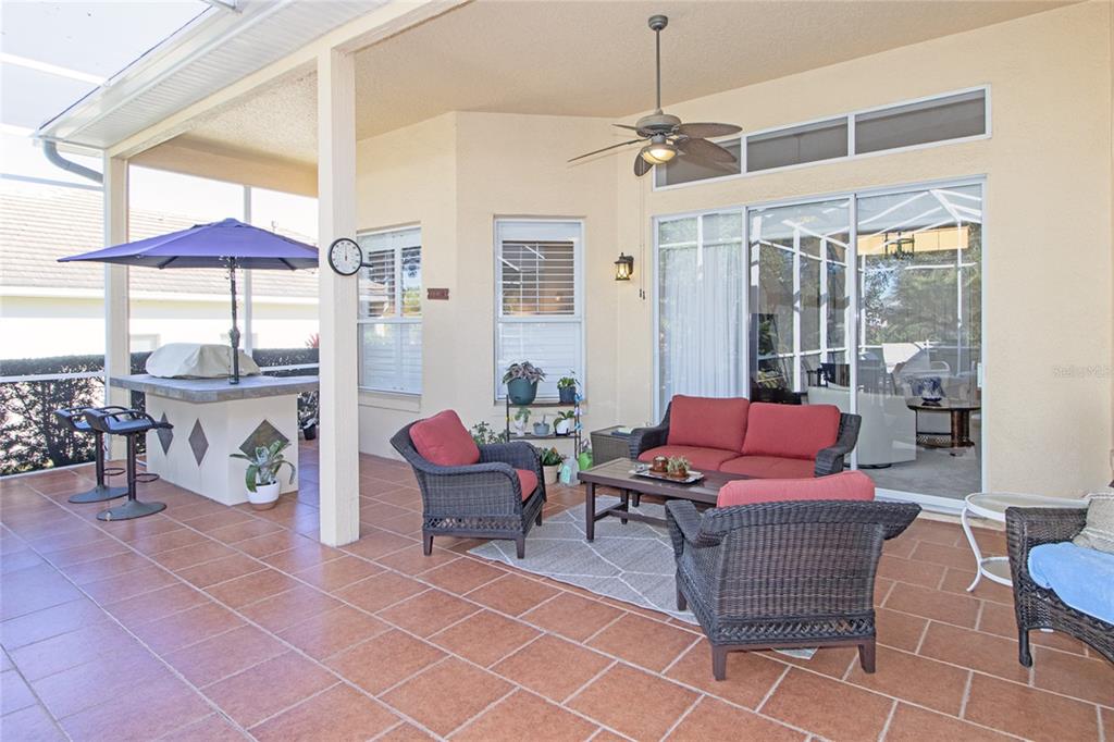 2808 Falcon Ridge Clermont, FL 34711 - Photo 38 of 65 a living room with patio furniture and a table