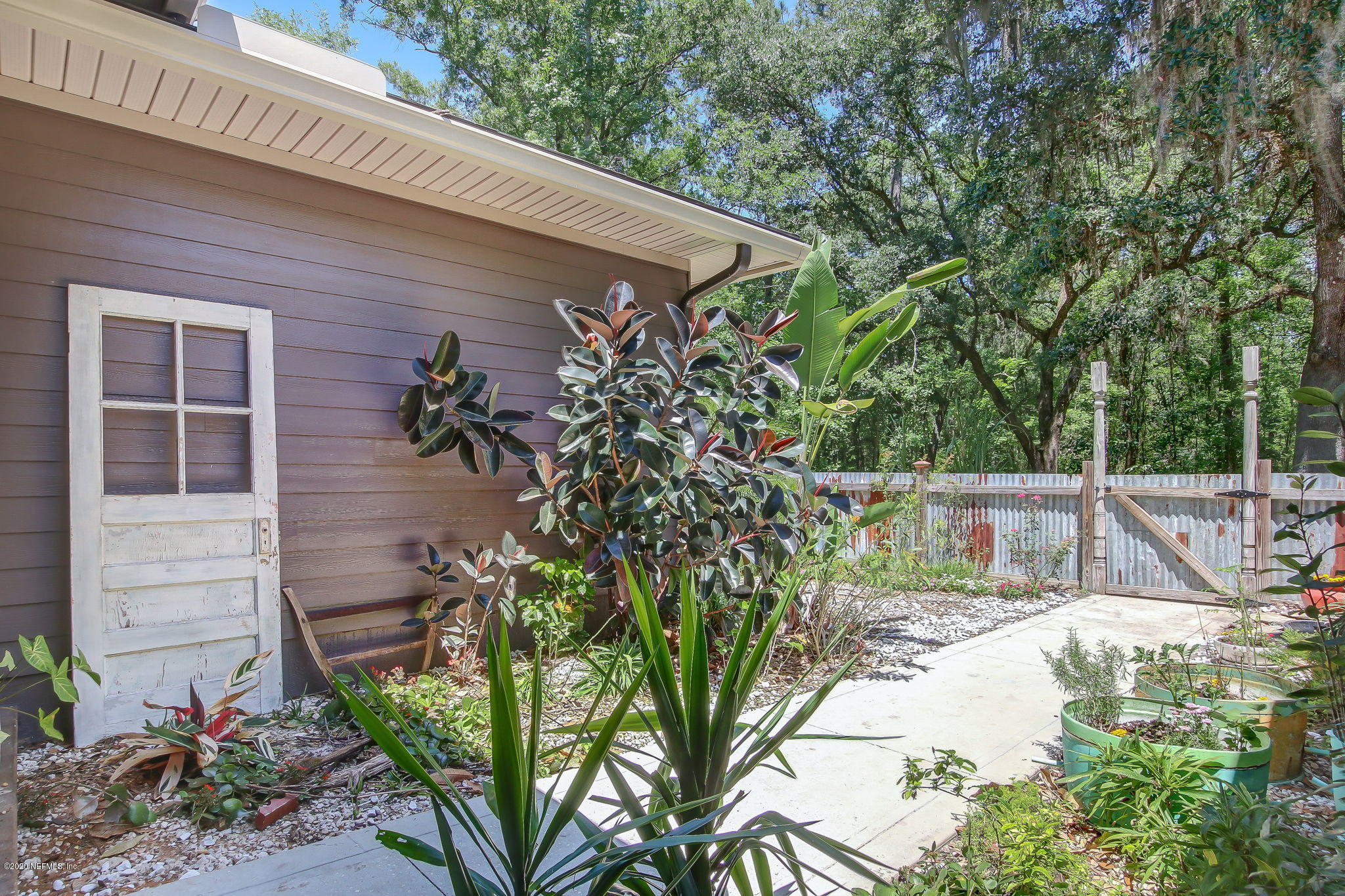 5049 Stephen Colee Road St. Augustine, FL 32092 - Photo 16 of 55 a view of a backyard with potted plants