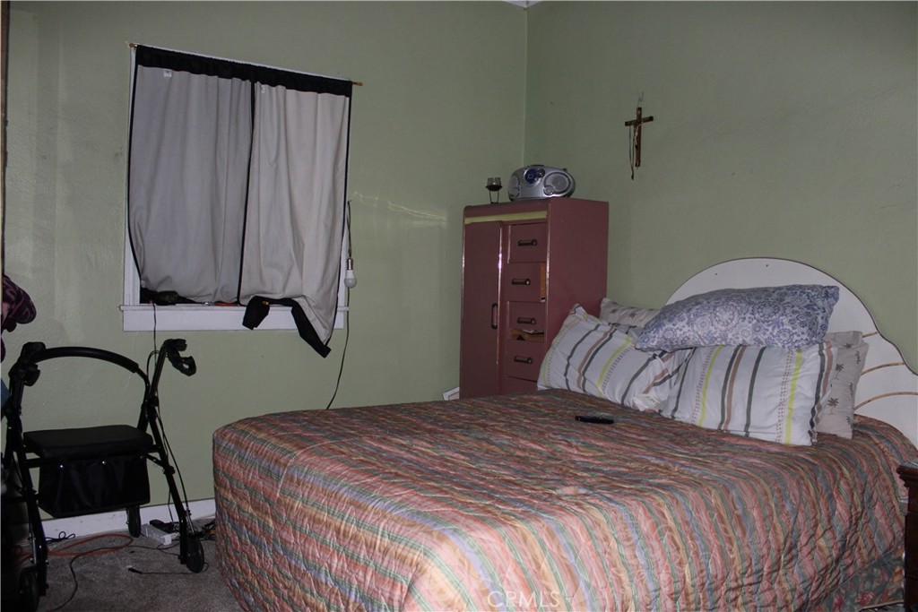 2723 Iris Street Riverside, CA 92507 - Photo 10 of 14 a bedroom with a bed and a dresser