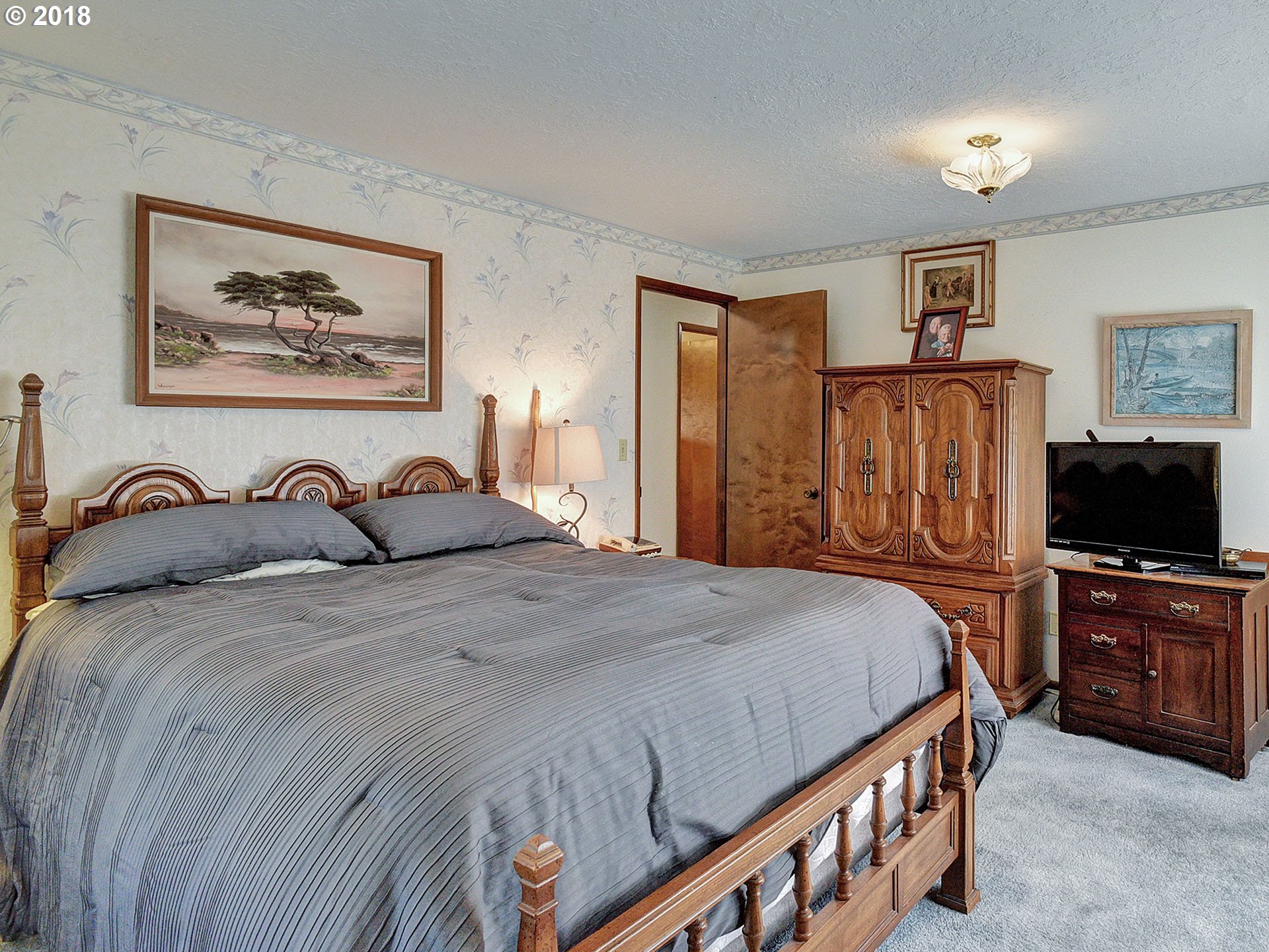 9850 South Barnards Road Canby, OR 97013 - Photo 15 of 32 a bedroom with a bed and a flat screen tv