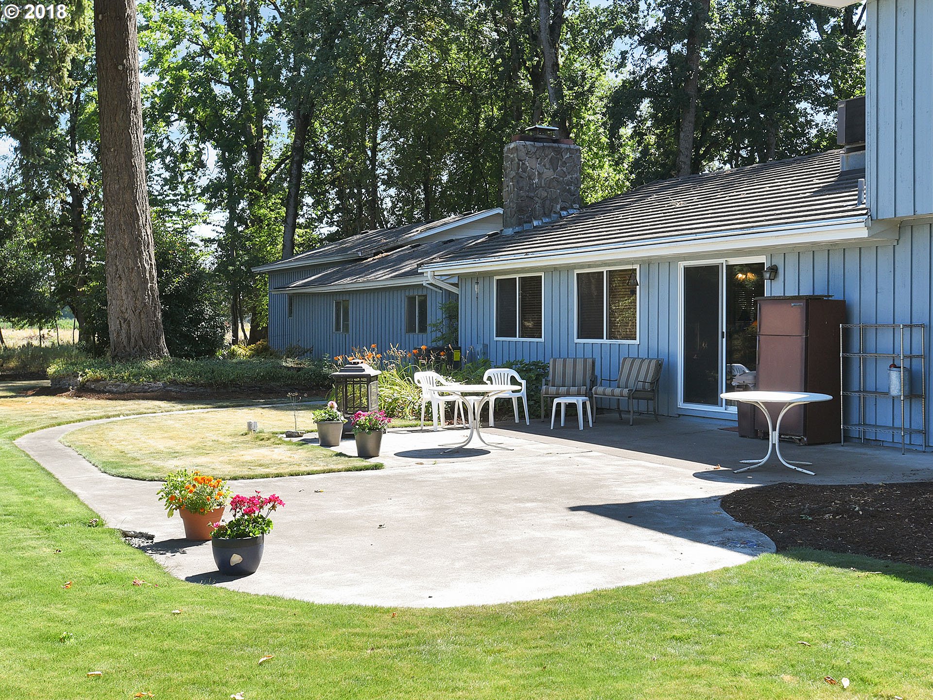 9850 South Barnards Road Canby, OR 97013 - Photo 32 of 32 a view of a house with backyard water fountain and sitting area