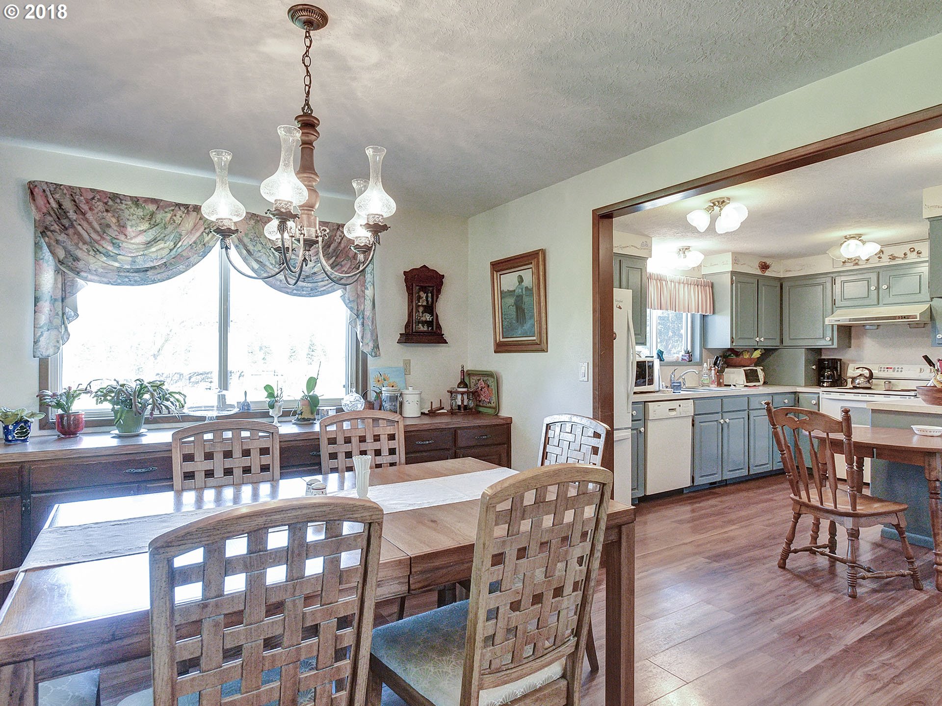 9850 South Barnards Road Canby, OR 97013 - Photo 7 of 32 a dining room filled chandelier and wooden floor