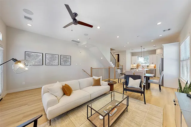 a living room with furniture and kitchen view