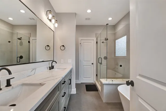 a bathroom with double vanity sinks and a mirror