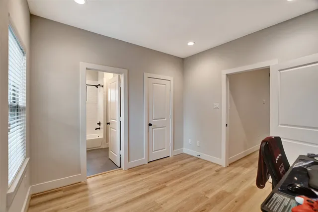 a bathroom with a granite countertop sink mirror vanity and toilet
