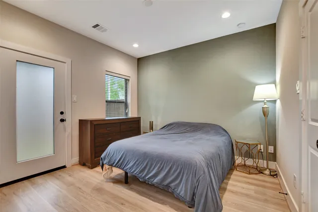 a bathroom with a sink a toilet a mirror and shower curtain