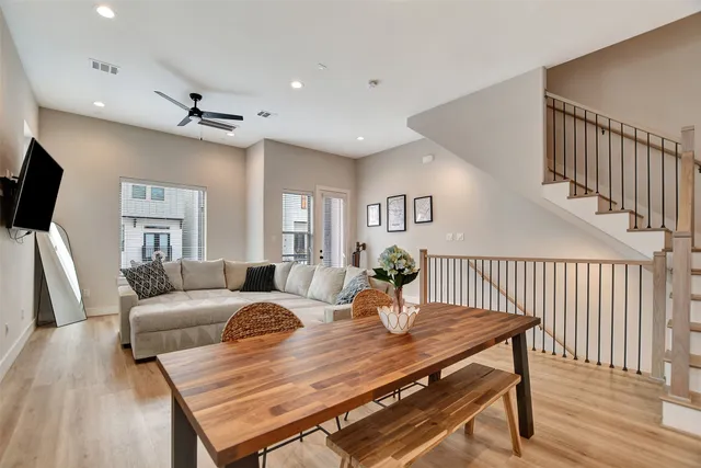 a living room with furniture a flat screen tv and a table