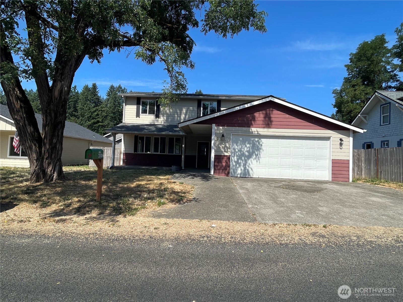 911 West Front Street Winlock, WA 98596 - Photo 1 of 30 a front view of a house with a yard and garage