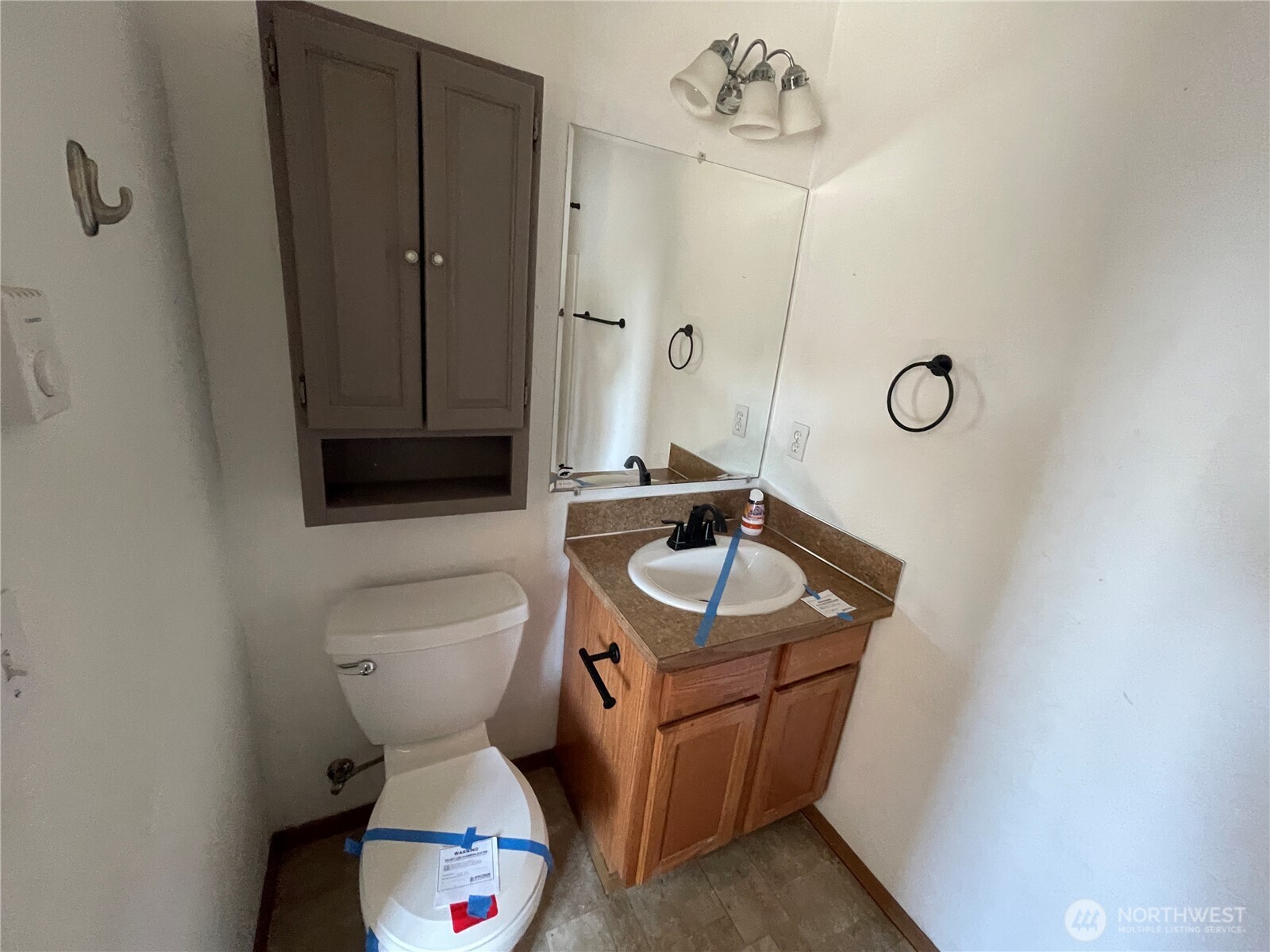 911 West Front Street Winlock, WA 98596 - Photo 22 of 30 a bathroom with a sink a toilet and mirror
