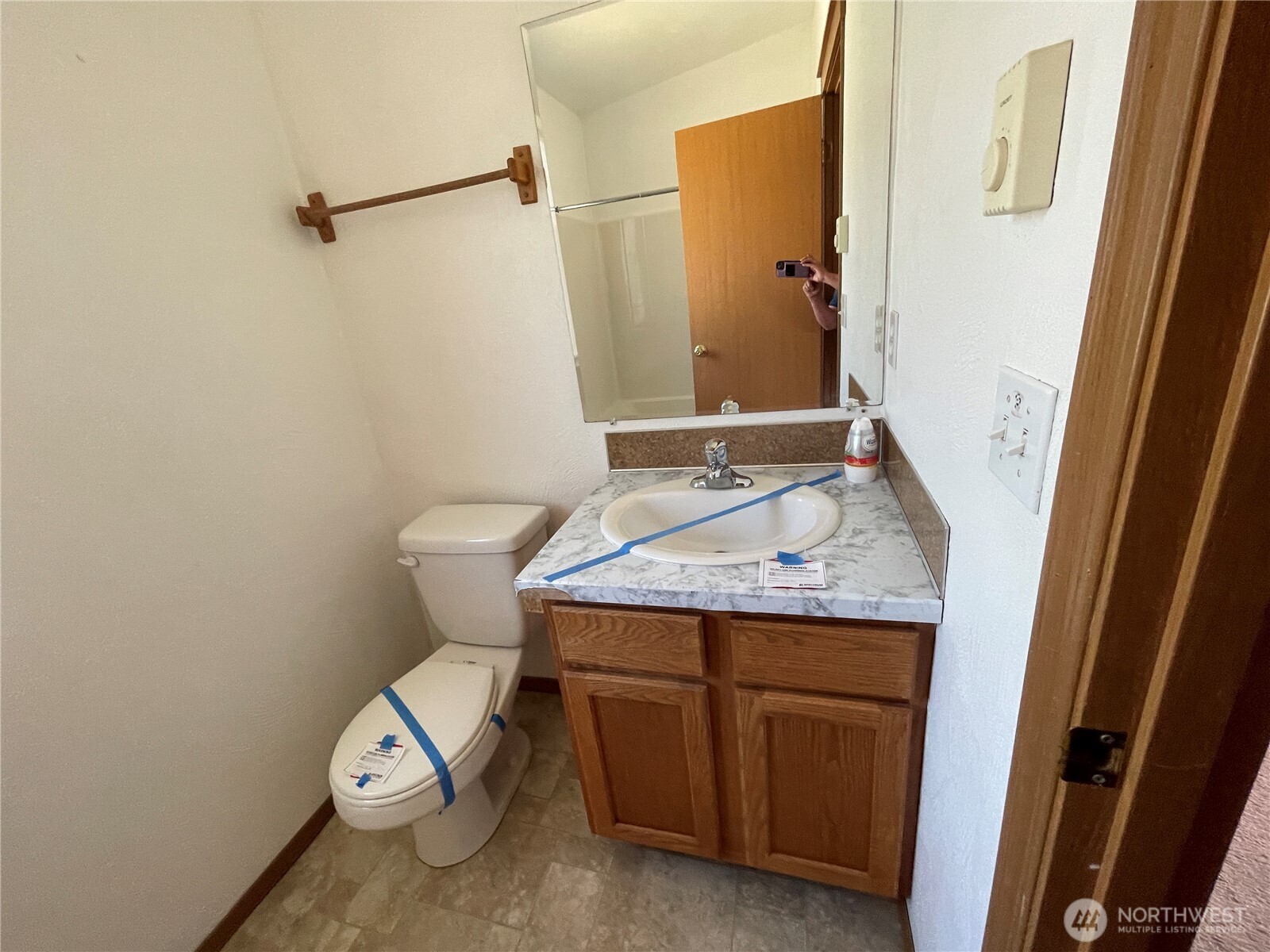 911 West Front Street Winlock, WA 98596 - Photo 26 of 30 a bathroom with a granite countertop sink and a toilet