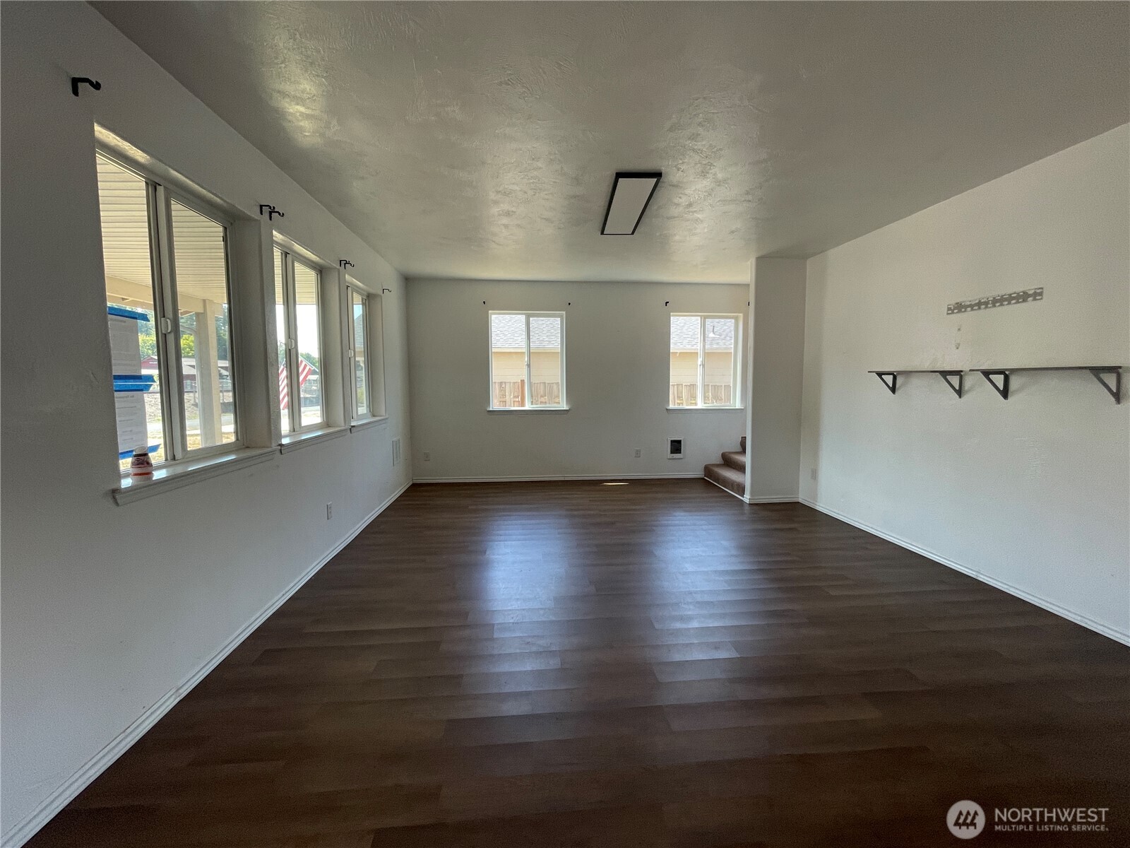 911 West Front Street Winlock, WA 98596 - Photo 4 of 30 an empty room with wooden floor and windows