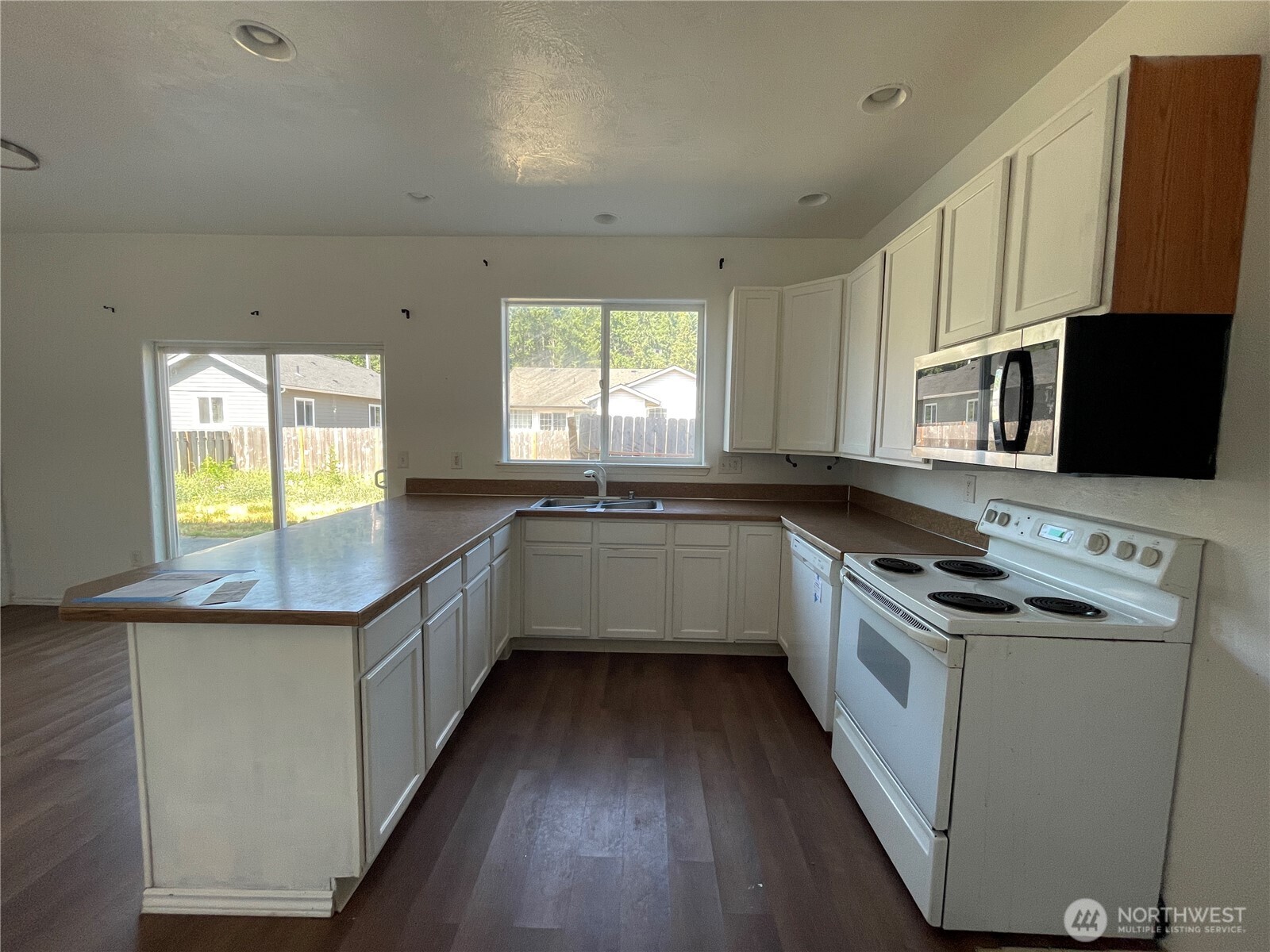 911 West Front Street Winlock, WA 98596 - Photo 7 of 30 a kitchen with stainless steel appliances kitchen island granite countertop a stove a sink and a microwave