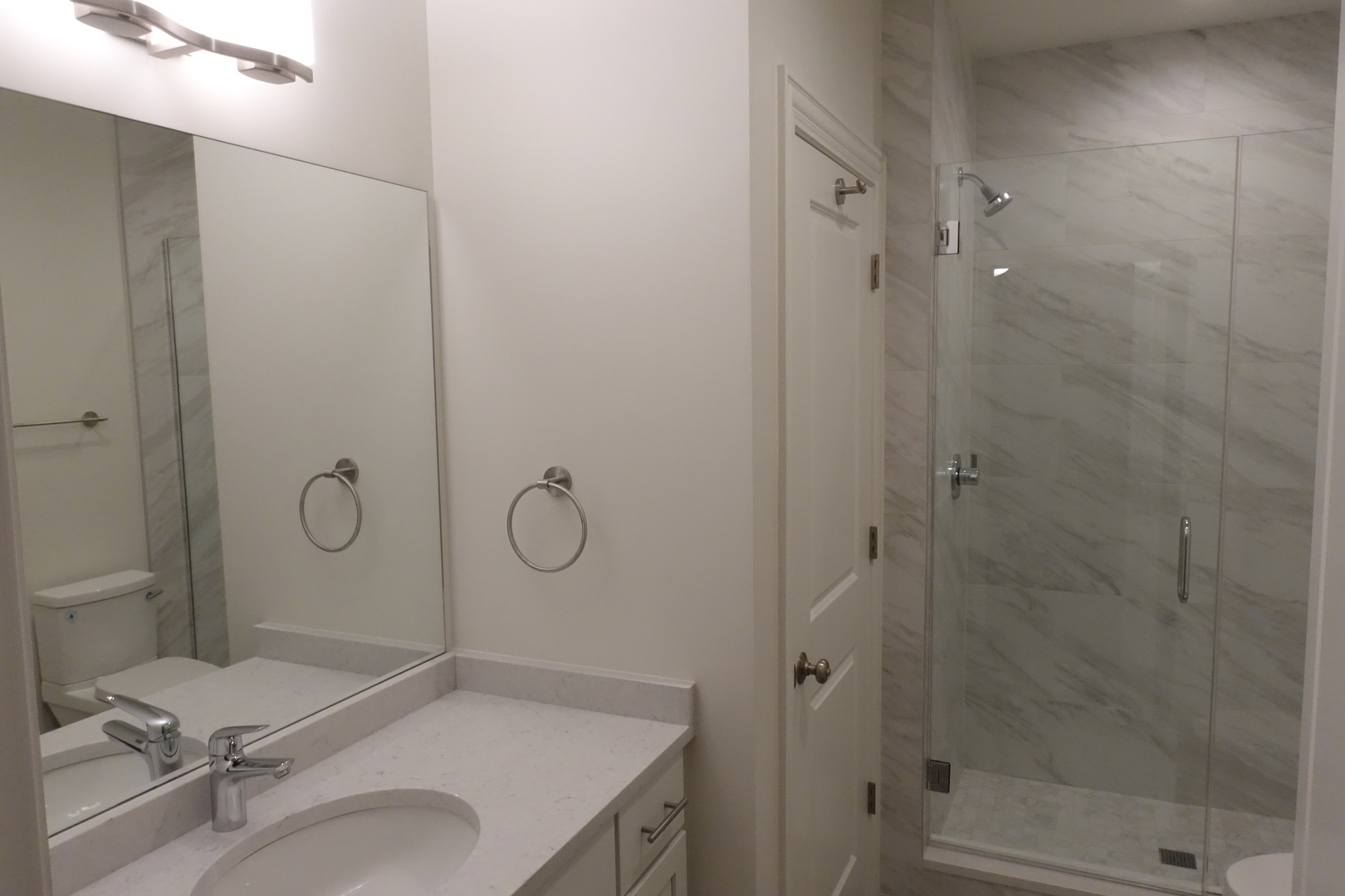 809 North Franklin Street, Unit 3F Chicago, IL 60610 - Photo 16 of 17 a bathroom with a granite countertop sink mirror vanity and toilet