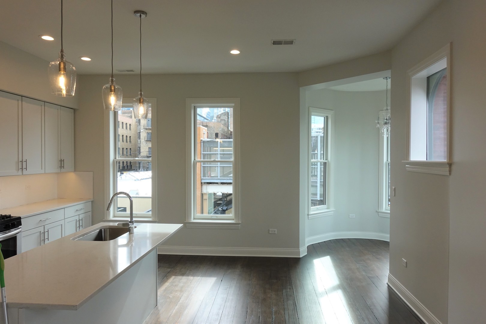 809 North Franklin Street, Unit 3F Chicago, IL 60610 - Photo 3 of 17 a view of a large kitchen with windows and chandelier