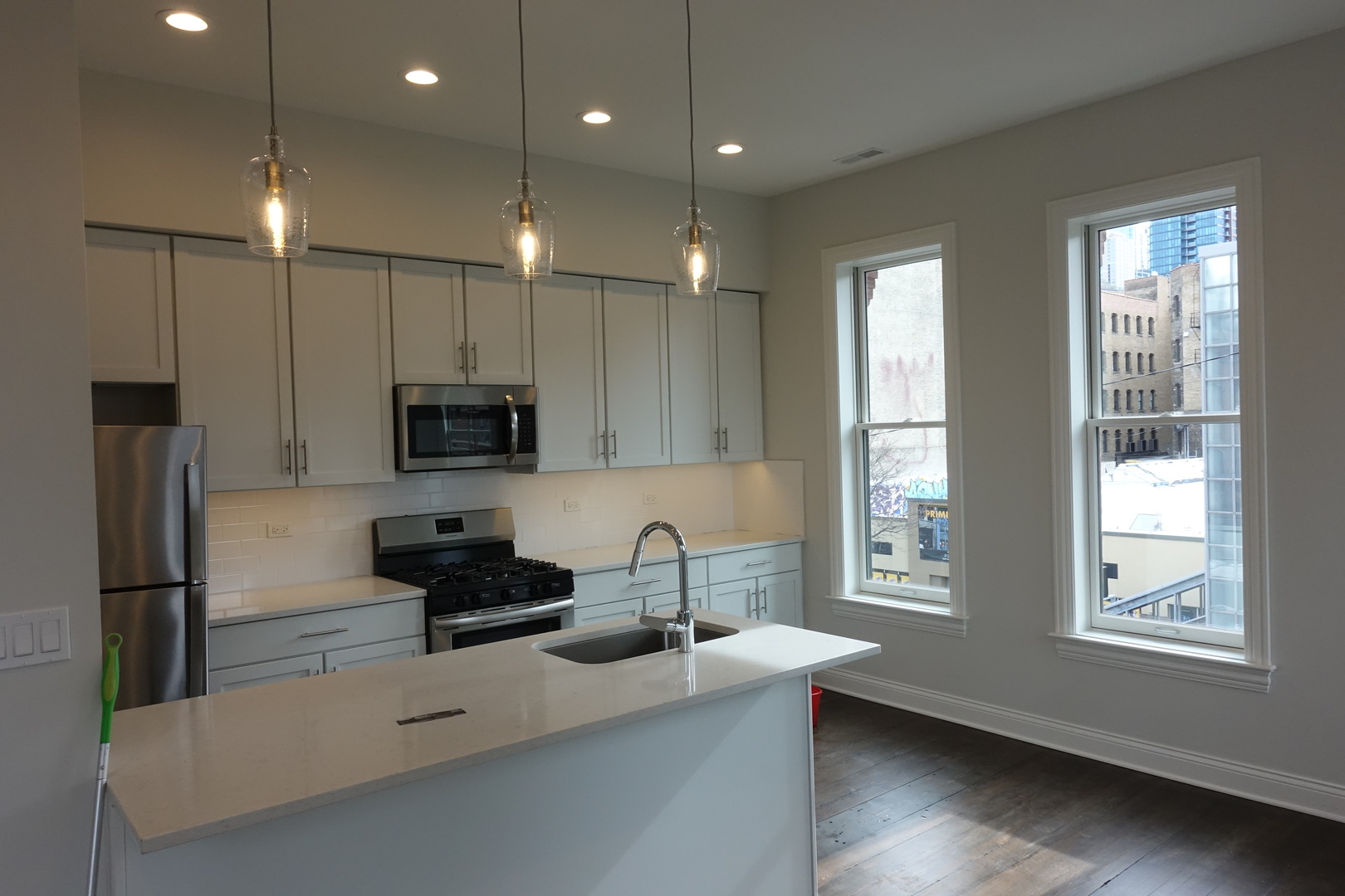 809 North Franklin Street, Unit 3F Chicago, IL 60610 - Photo 4 of 17 a kitchen with stainless steel appliances a sink stove and refrigerator