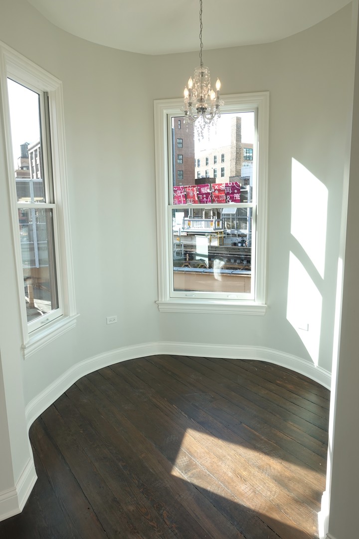 809 North Franklin Street, Unit 3F Chicago, IL 60610 - Photo 6 of 17 a view of a room wooden floor and chandelier