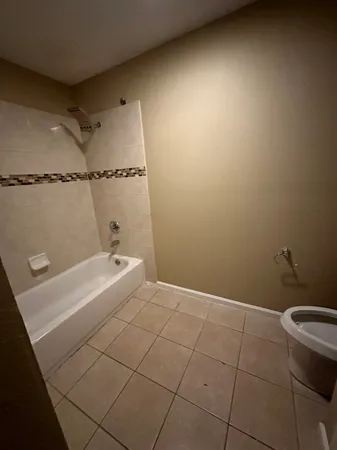 a bathroom with a granite countertop sink and toilet