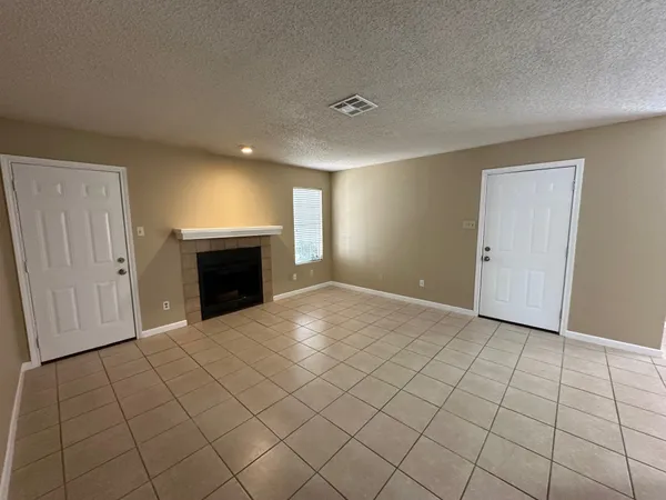 a view of an empty room with a fireplace