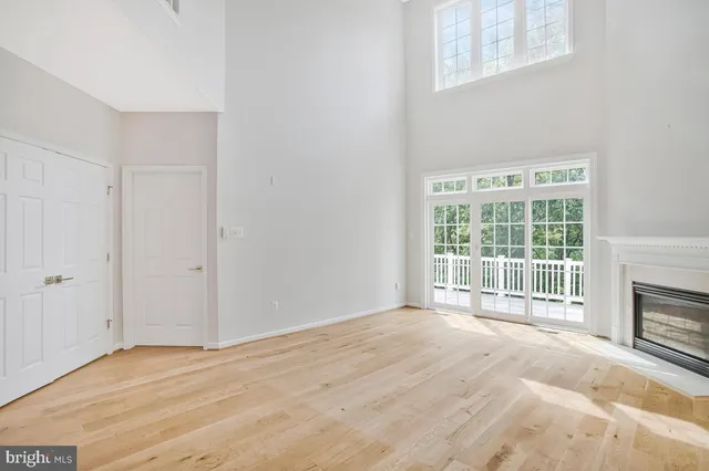 a balcony with wooden floor and trees in the back