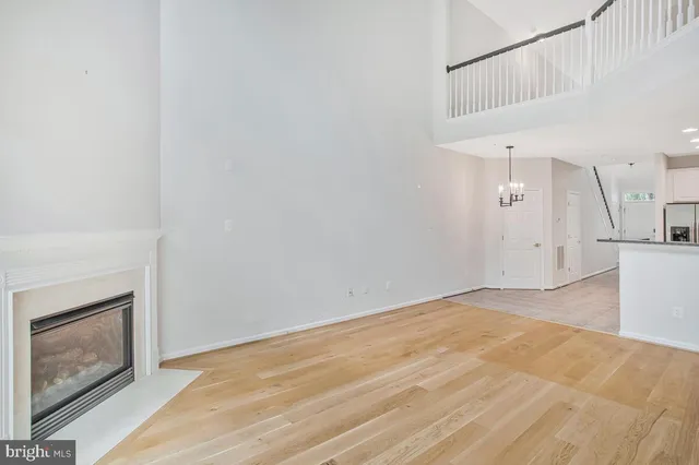 a view of a grassy field with trees in the background