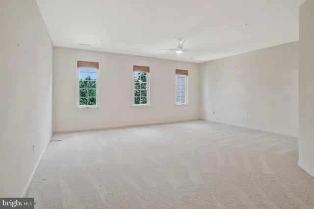 a car parked in front of a house with a small yard