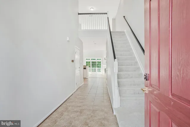 an empty room with wooden floor and fireplace
