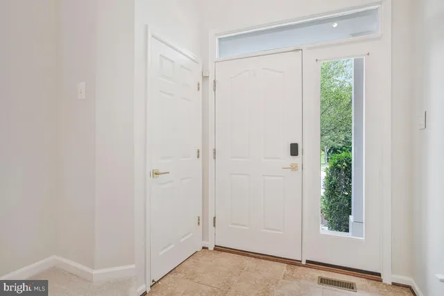 a view of empty room with wooden floor and fireplace