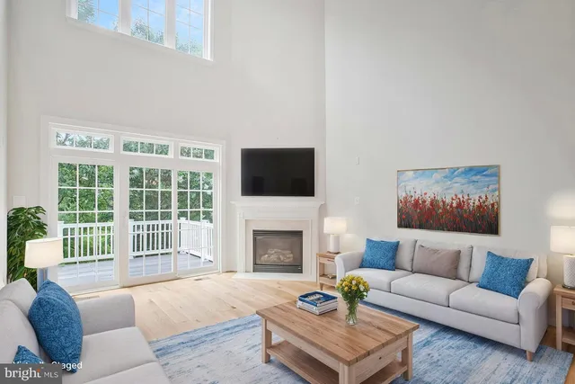 a kitchen with stainless steel appliances granite countertop white cabinets a refrigerator a stove a sink and white cabinets