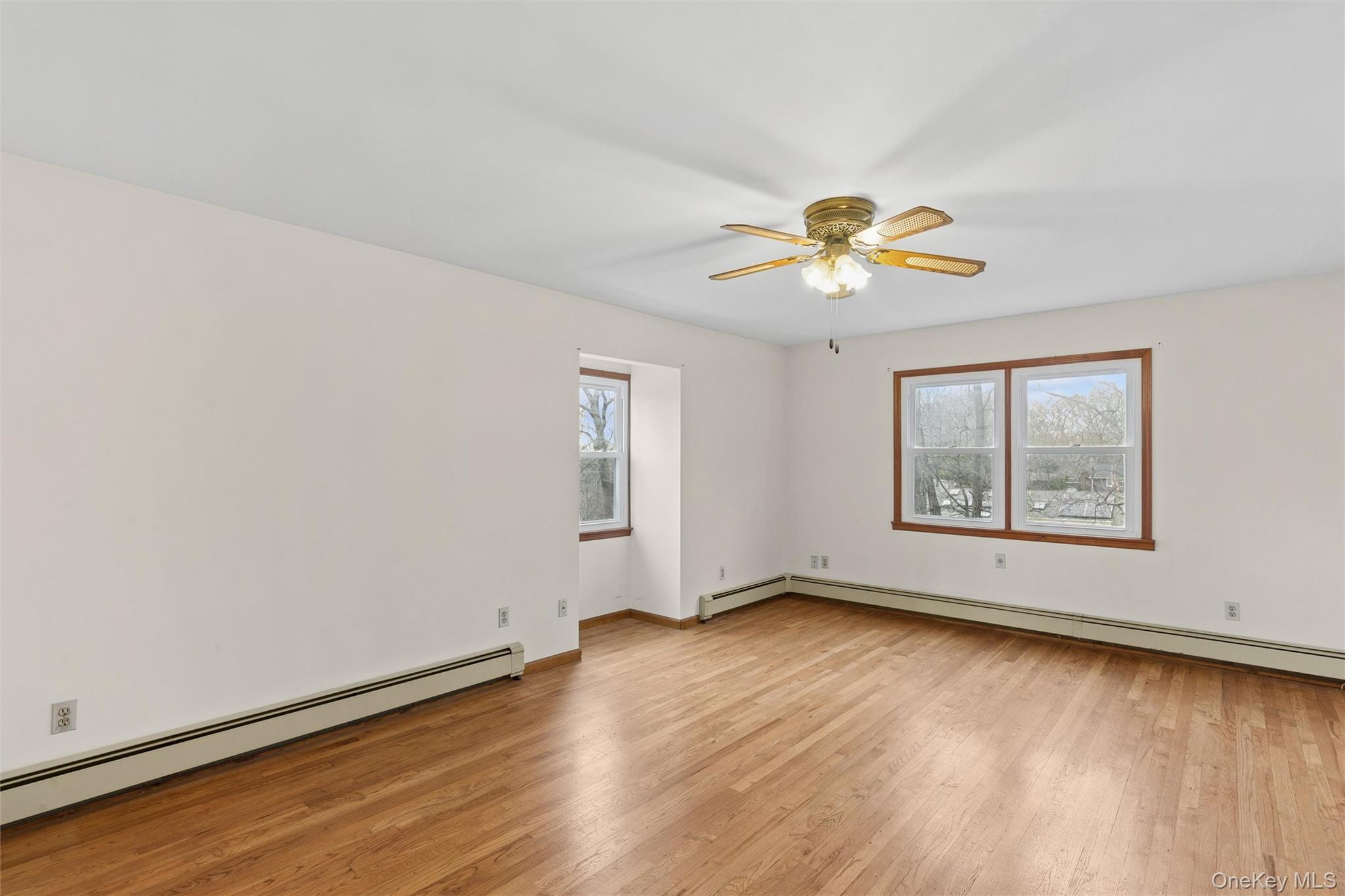 49 Overhill Road Wading River, NY 11792 - Photo 13 of 27 a view of an empty room with window and wooden floor