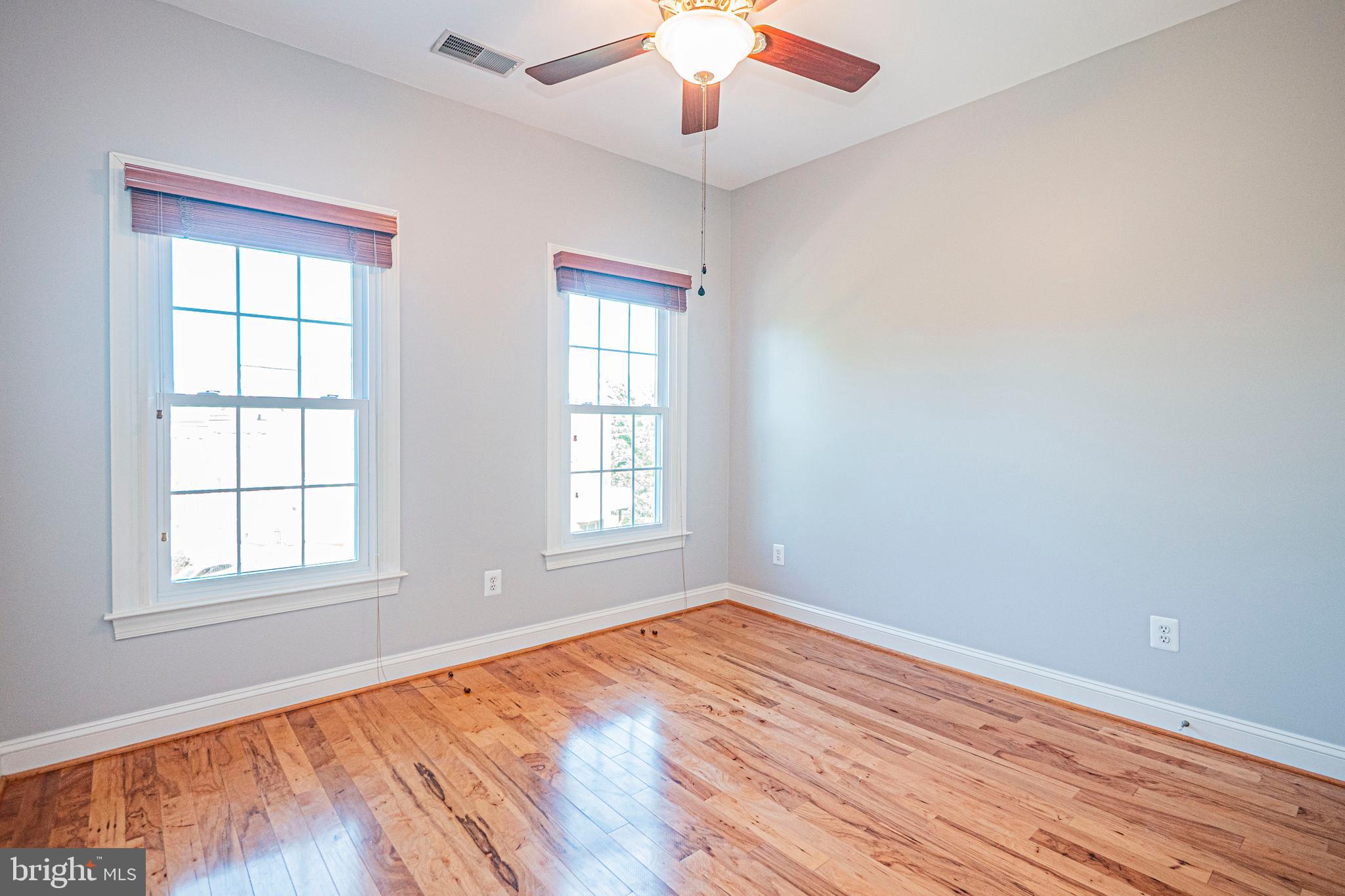 5448 Edsall Ridge Place Alexandria, VA 22312 - Photo 31 of 52 an empty room with wooden floor cabinet and windows