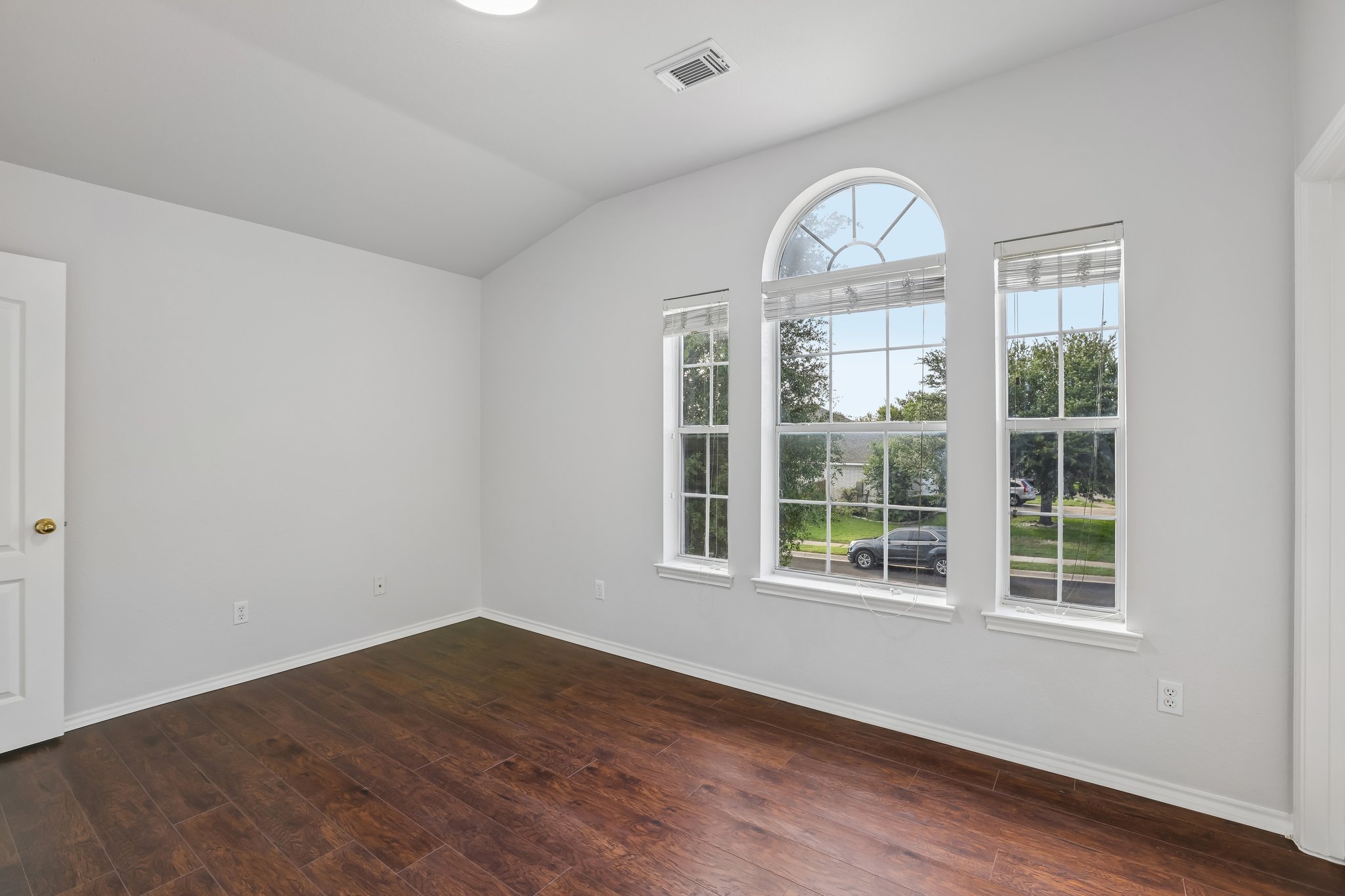 1721 Long Rifle Drive Austin, TX 78754 - Photo 26 of 38 Sun-drenched interiors showcase rich hardwood flooring and a gracefully arched window overlooking the neighborhood.