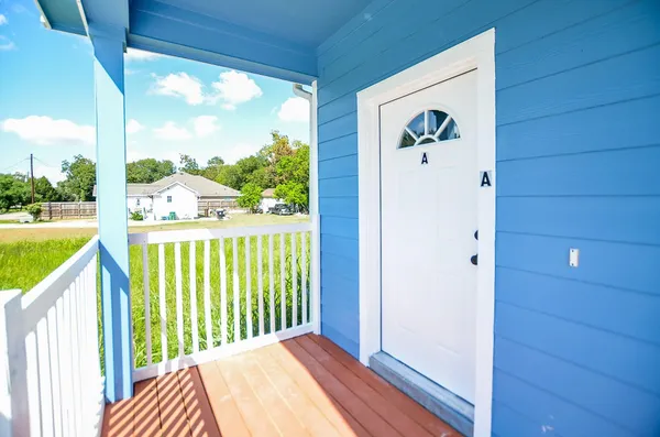 a view of balcony with floor to ceiling window wooden floor and fence