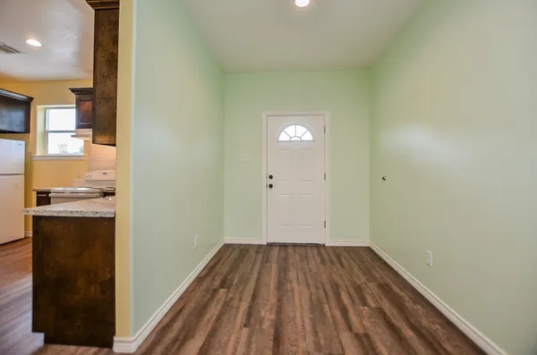 a view of a kitchen from the hallway