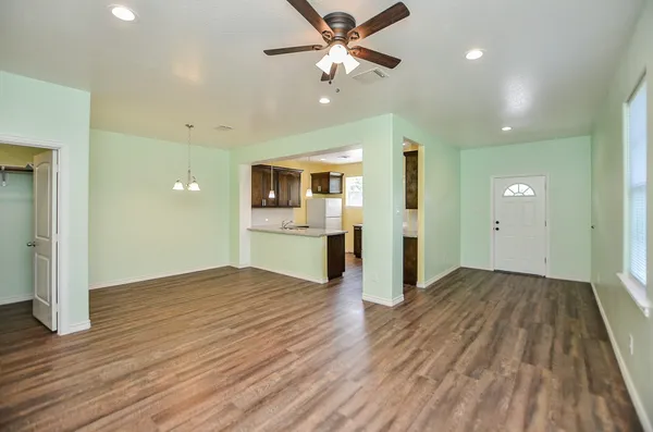 wooden floor in an empty room with a window