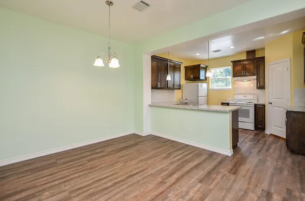 a view of a kitchen counter space and wooden floor