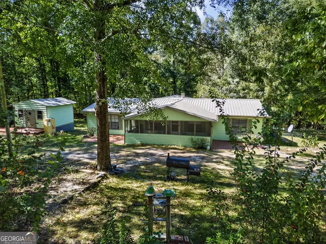 a backyard of a house with yard barbeque oven and outdoor seating