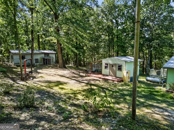 a view of a chair and table in backyard of the house