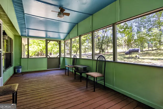 a view of a chairs and table in the balcony