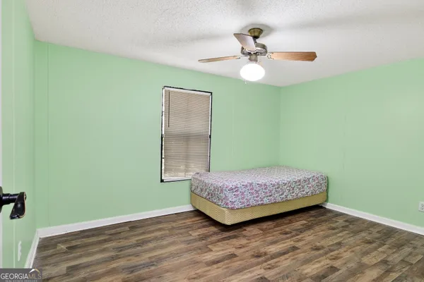 a view of a room with air conditioner duct and wooden floor