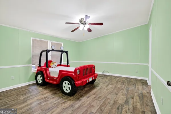 a view of a room with wooden floor and windows