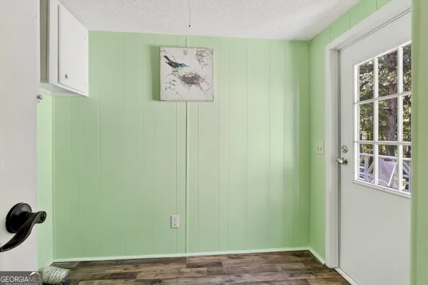a en suite bathroom with a granite countertop sink and a mirror