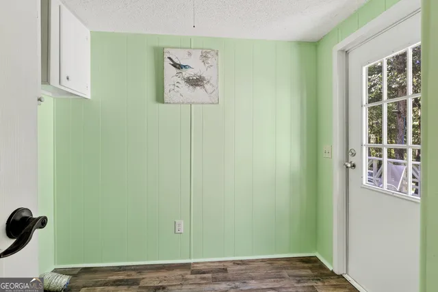 a view of a room with wooden floor and windows