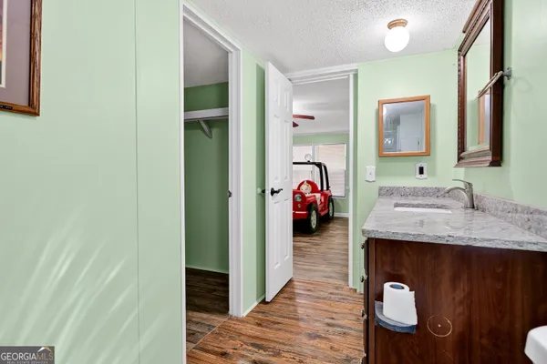 a kitchen with stainless steel appliances granite countertop a sink and a wooden floor