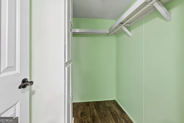 a view of a room with wooden floor and cabinet