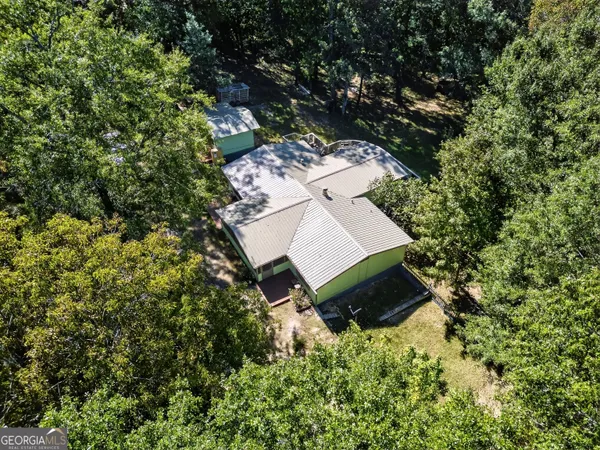 an aerial view of a house with a yard