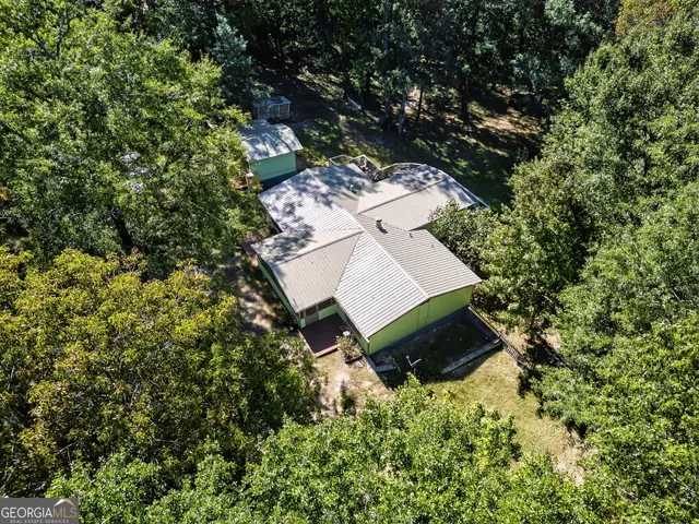 an aerial view of a house with a yard