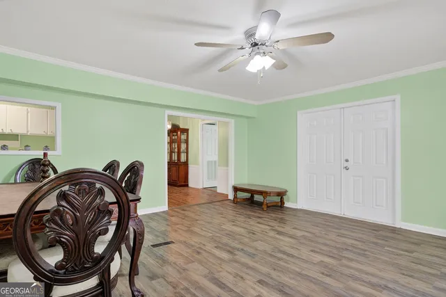 a view of a livingroom with furniture hardwood floor and a ceiling fan