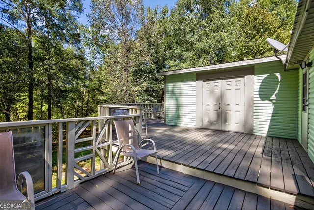 a view of balcony with wooden floor and outdoor seating